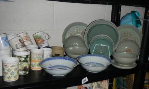 A mixed lot of ceramic plates, cups etc.,