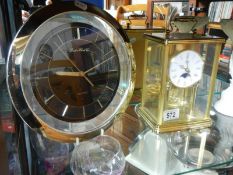 A mantel clock and a wall clock.