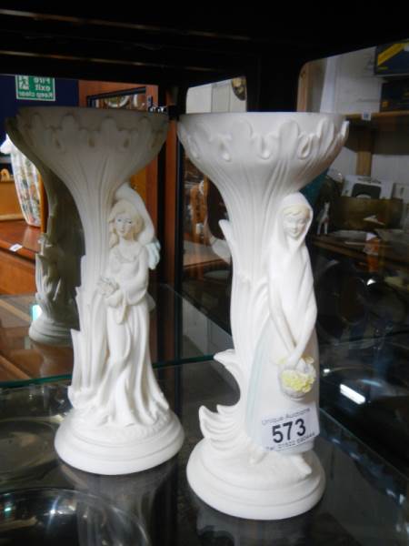 A pair of figural pedestal ornaments.