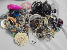 A bag of assorted costume jewellery.