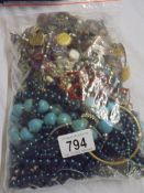 A bag of assorted costume jewellery.