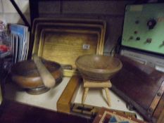 A set of three wooden trays and other wooden items.