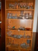 Five shelves of assorted glass ware.