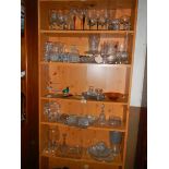 Five shelves of assorted glass ware.