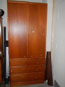 A good quality teak double door cabinet on drawer base.