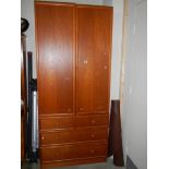 A good quality teak double door cabinet on drawer base.