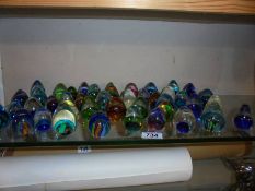 Over 40 small, paperweight style glass ornaments.