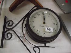 An outdoor double sided clock/barometer