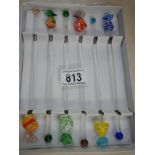 A Boxed set of glass cocktail stirrers.