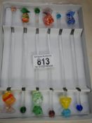 A Boxed set of glass cocktail stirrers.