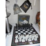 A boxed Harry Potter chess set. Wizard missing, black pawn, black knight and white castle.