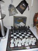 A boxed Harry Potter chess set. Wizard missing, black pawn, black knight and white castle.