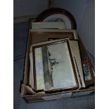 A box of frames and old pictures.