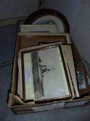 A box of frames and old pictures.