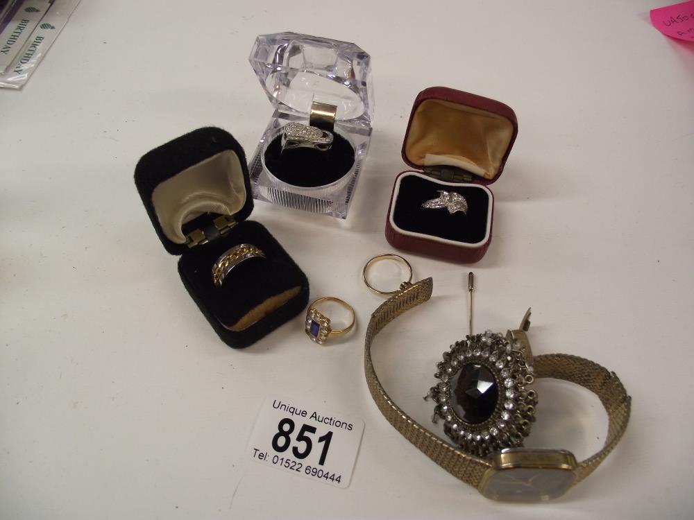 A quantity of costume rings and a watch