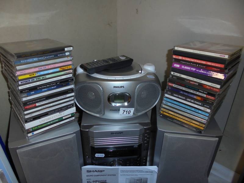 A Sharp music system, Phillips cd player and quantity of CD's.