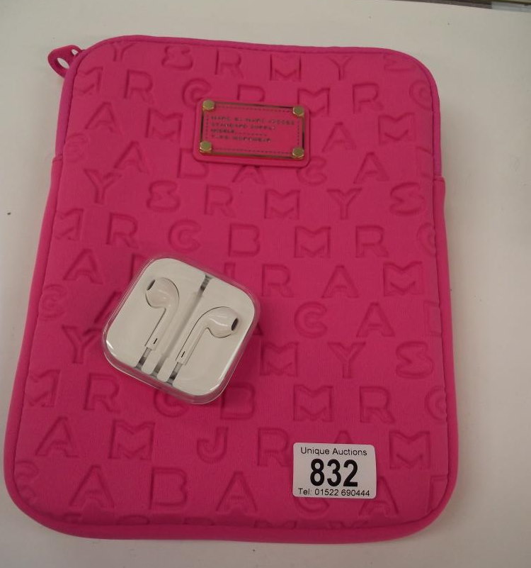 A brand new boxed Apple earphones and an I-pad case from Marc by Marc Jacobs