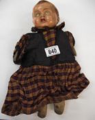 A vintage composition headed doll.