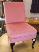 A pink draylon bedroom chair on Queen Anne legs