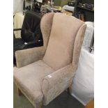 A brown draylon wing arm chair