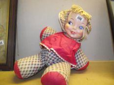 A large vintage rag doll with celluloid