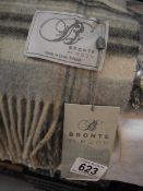 A 100% pure Merino wool throw by Bronte by Moon, new with tags, colour reads 'heather check grey' on