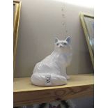 A large china ornament of a white cat. Height 25cm.