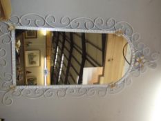 A wrought iron framed mirror