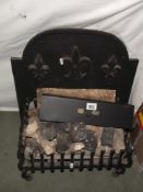 An iron fire basket with cast iron fire back