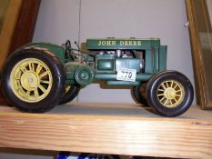 A large pressed steel model of a vintage John Deere tractor (missing 1 mudguard).