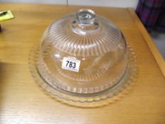 A glass lidded cake dome