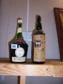 A bottle of Benedictine Liqueur and an empty 1957 White Horse bottle.