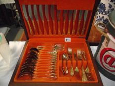 A vintage 42 piece gold plated cutlery set, made in Sheffield