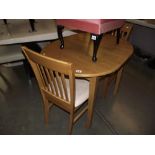 A small extending oval dining table for 2 (includes 2 chairs)