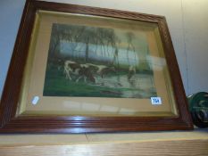 An Edwardian oak framed print of cattle drinking from a pond.