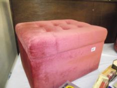 A pink draylon bedroom storage box/stool