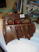 A pipe rack and 4 vintage pipes