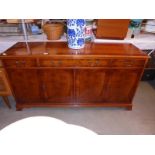 A sideboard with flame mahogany veneered finish, 4 doors, 3 drawers