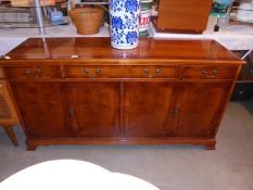 A sideboard with flame mahogany veneered finish, 4 doors, 3 drawers