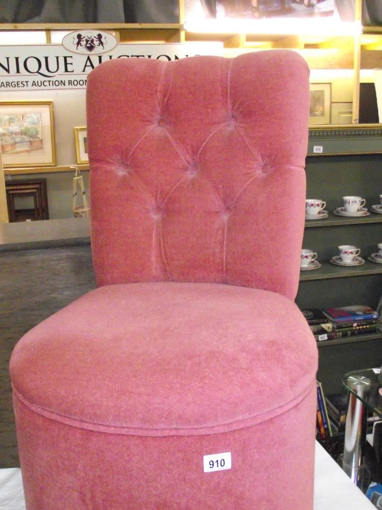 A pink draylon bedroom chair