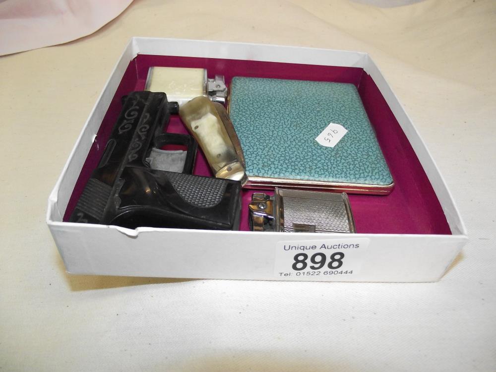 A quantity of lighters including one shaped like a pistol, cigarette case and penknife