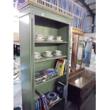 A tall green bookcase