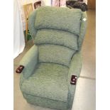 A green fabric electric recliner chair