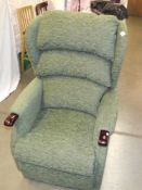 A green fabric electric recliner chair