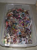 A large box of costume jewellery including large lot of bangles