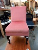 A pink Draylon bedroom chair on Queen Anne legs
