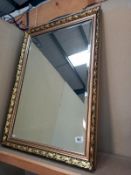 A gilt framed, bevel edge mirror. 61cm x 87cm.