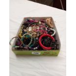 A large tray of costume jewellery.