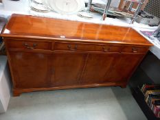 A sideboard with flame mahogany veneered finish, 4 doors, 3 drawers