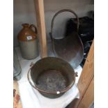 A copper and brass log basket on lion paw feet, a Victorian jam pan and a stoneware flagon